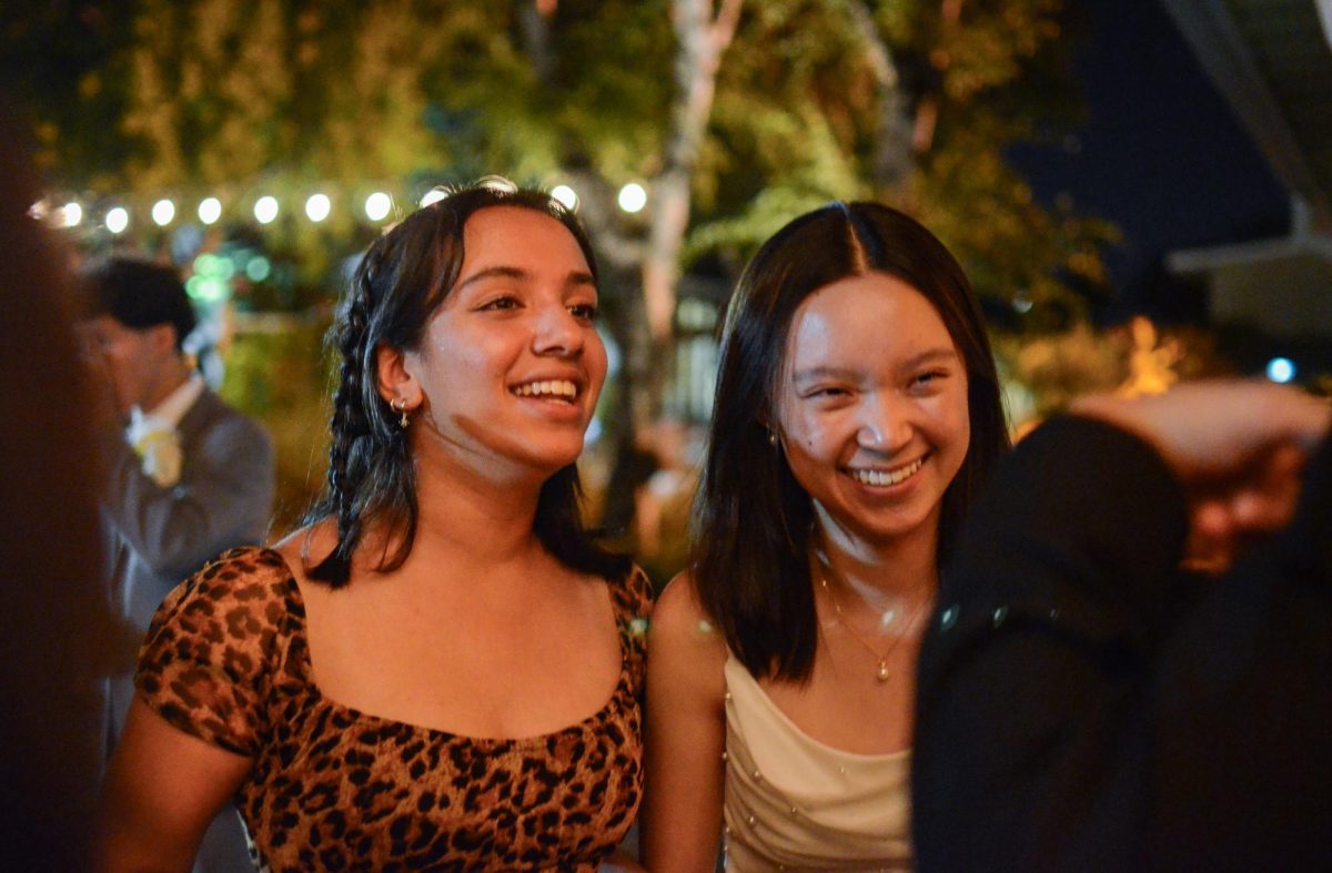 Sophomores Megha Unny and Sophia Zhu laugh while chatting in the quad. Students relaxed outside to take a break from dancing and play cornhole or foosbal.