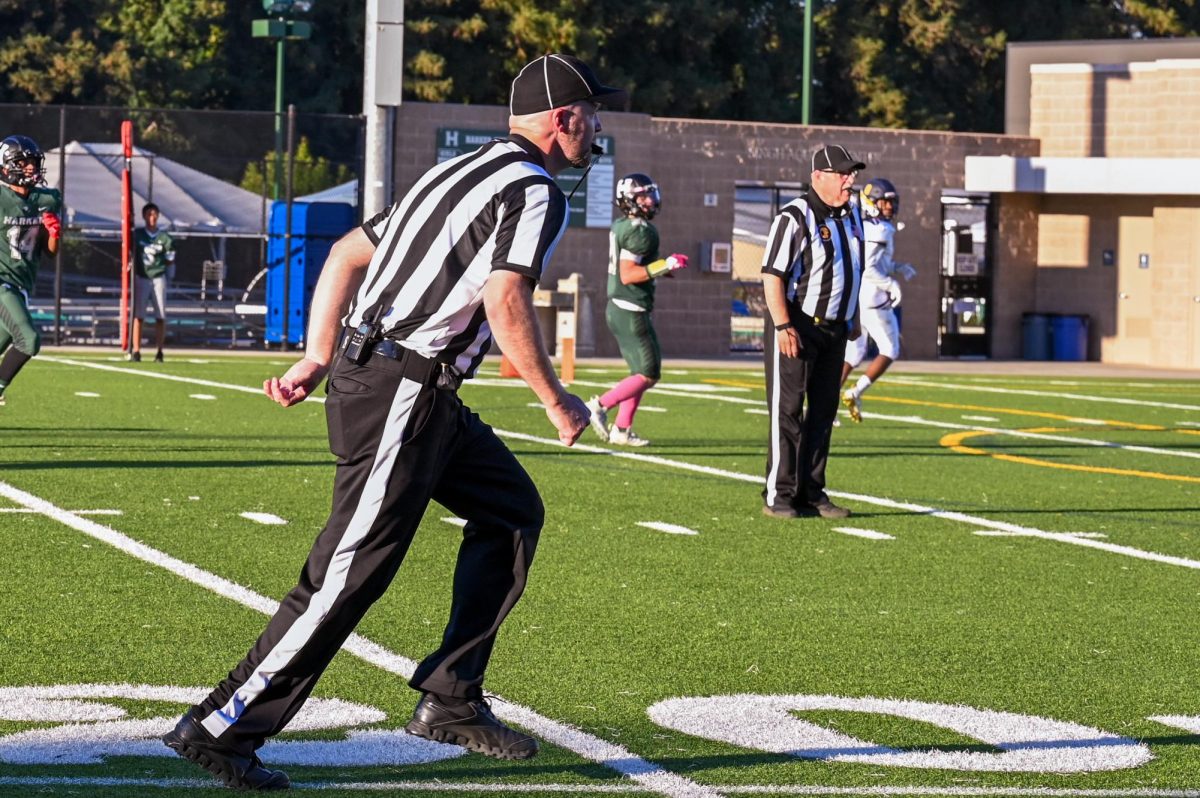 A referee blows his whistle during the varsity football team's season opener against Cornerstone Christian. The current referee shortage has forced athletics programs to reschedule games. 