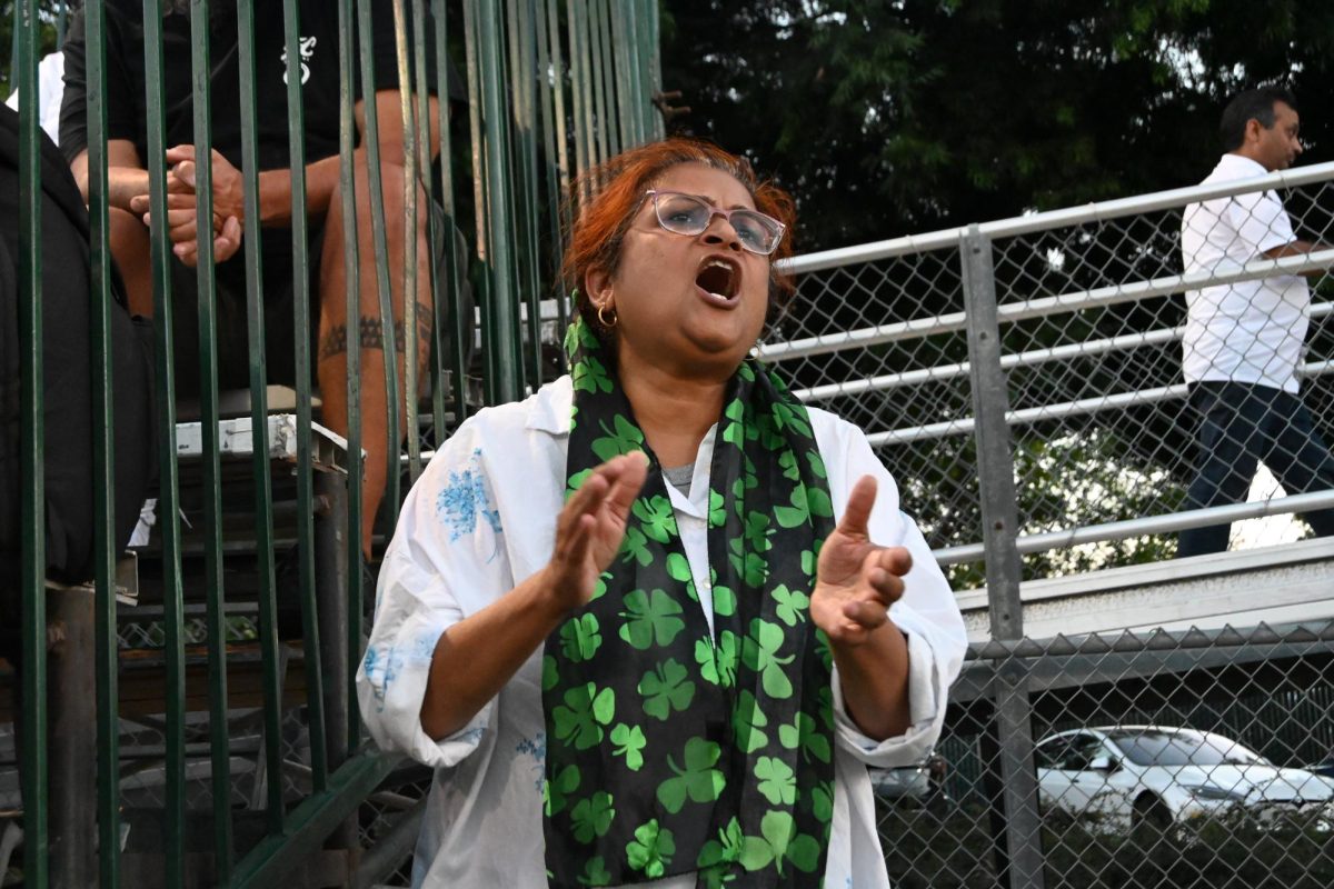 Siddarth's mother Nandini sundaram cheers the team on during the second quarter. The Eagle's lead 12-0 after a second touchdown by running back Jackson.