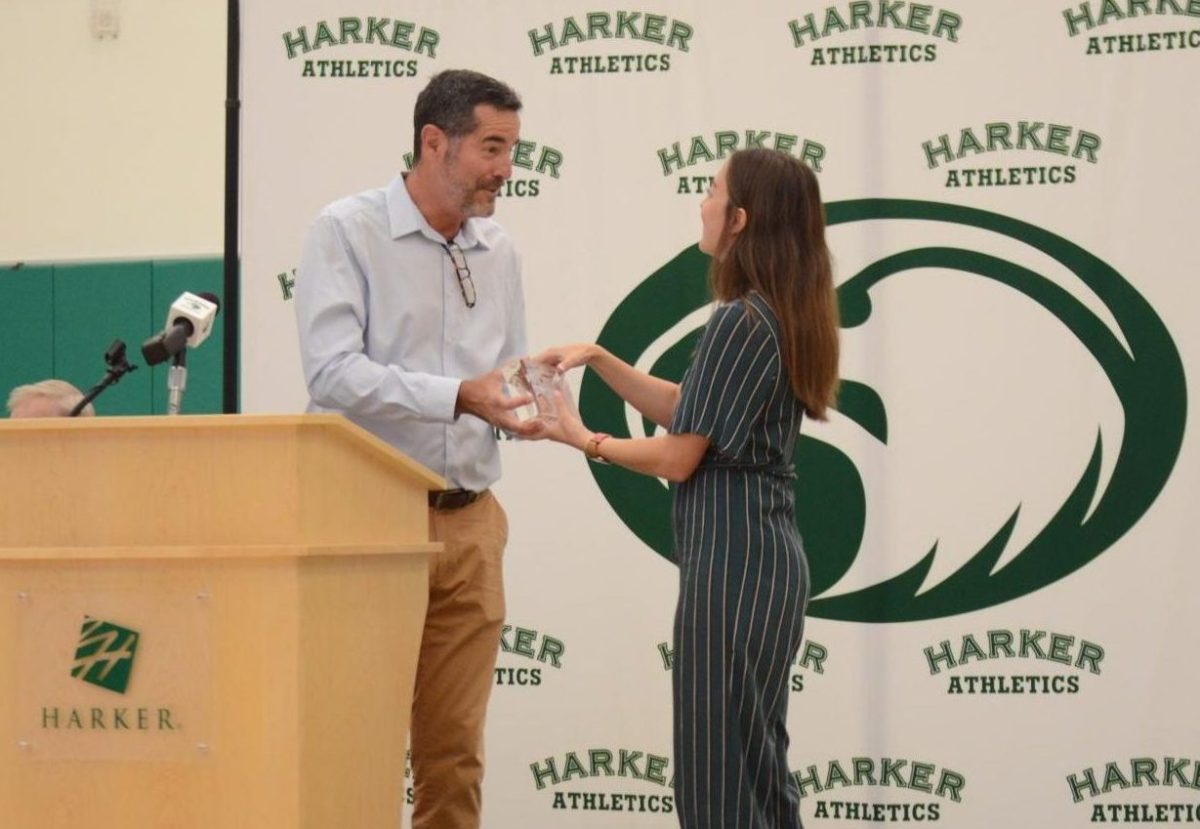 Athletic Director Dan Molin presents Kailee Gifford (’17) with her glass plaque during the Athletic Hall of Fame ceremony on Oct. 5. During her time at Harker, Gifford played on the varsity soccer, basketball and football teams.