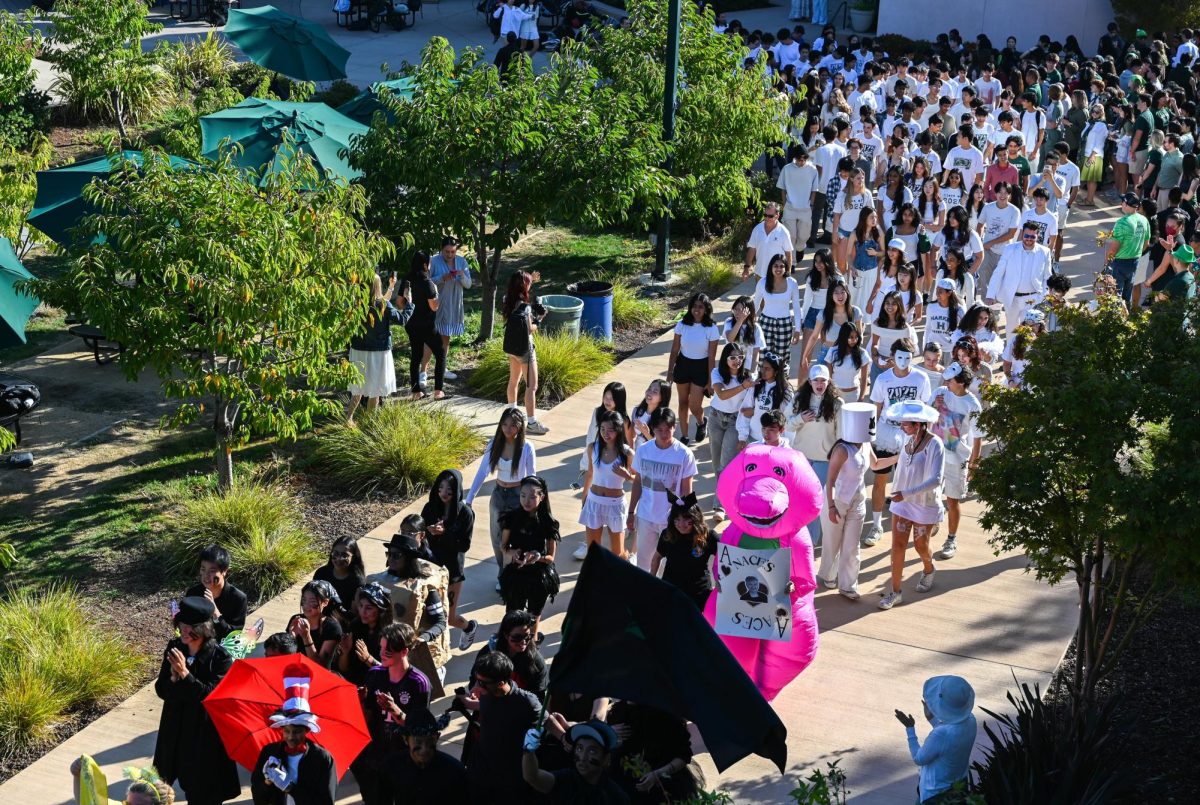 Dressed in their class color of white, the seniors make their way to Davis Field. The spirit parade is led by Pep Band and advisory representatives from each grade.