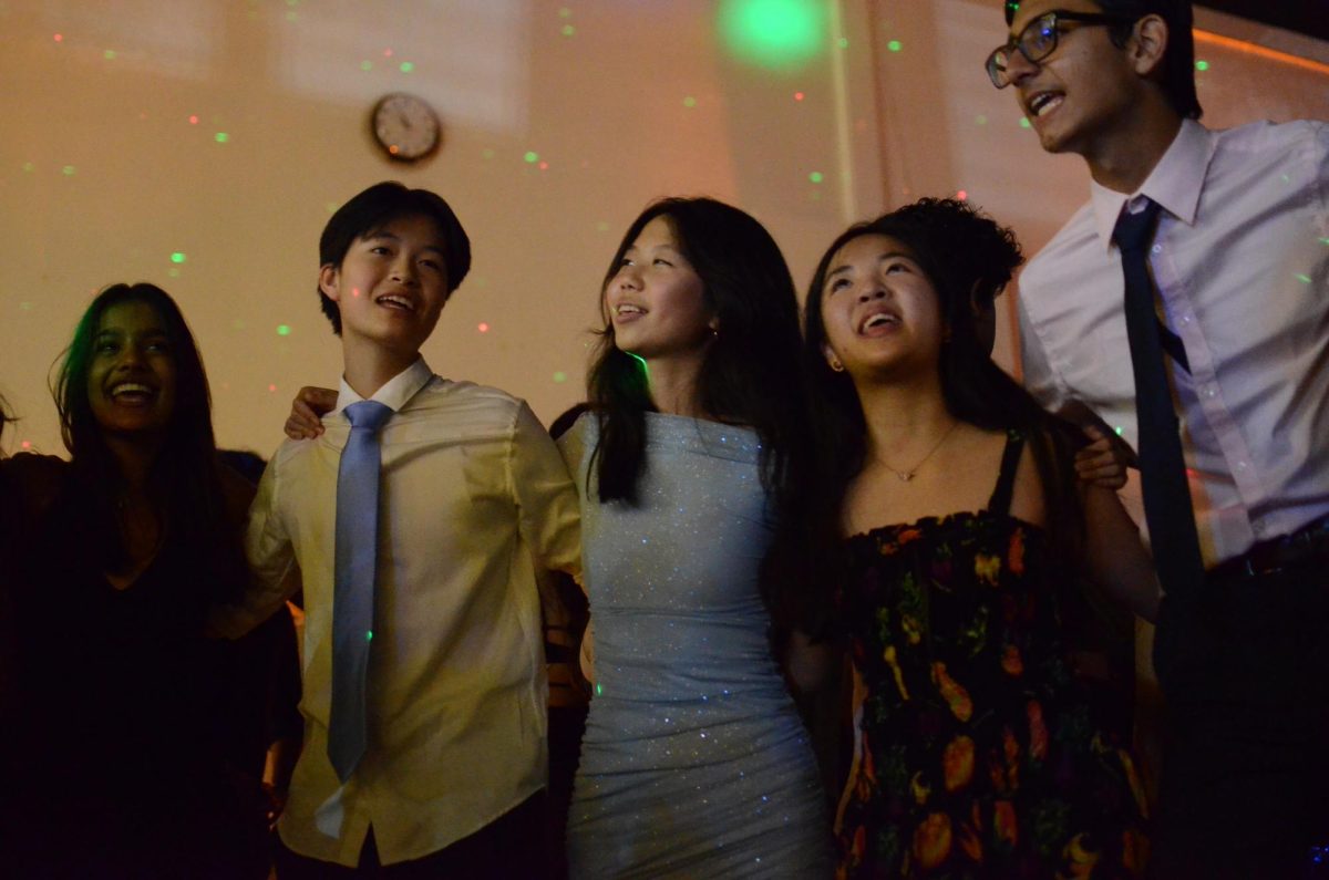 Sophomore Grace Fu sings with her friends in a circle as they sway to the beat of a song. The DJ played a total of four slow songs during the Fall Ball.