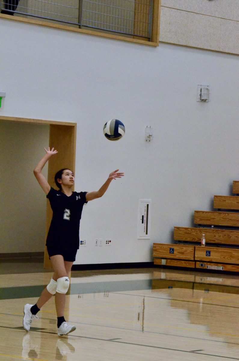 Setter Emma Lee (10) prepares to serve the ball during the second set of the junior varsity girls volleyball game against Eastside College Prep on Oct. 8. The team destroyed their opponents in two sets 25-2, 25-0. 