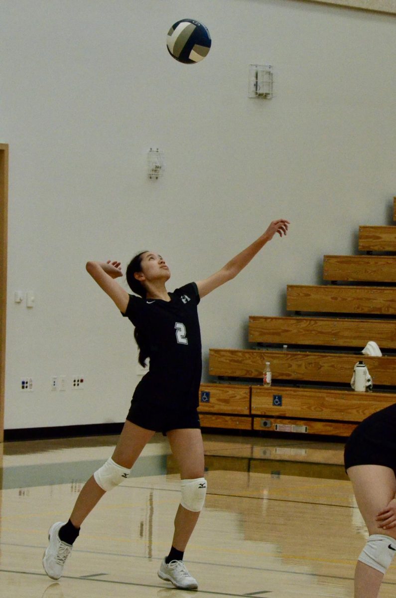 Setter Emma Lee (10) prepares to serve the ball during the second set of the junior varsity girls volleyball game against Eastside College Prep on Oct. 8. The team destroyed their opponents in two sets 25-2, 25-0. 