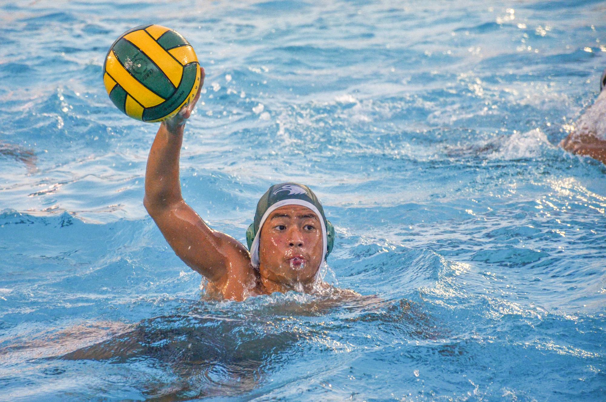 Sam Li (10) holds the ball overhead to fake a shot before passing it to a teammate for an assist. Sam demonstrated teamwork and communication throughout the game, setting up three goals for his teammates.