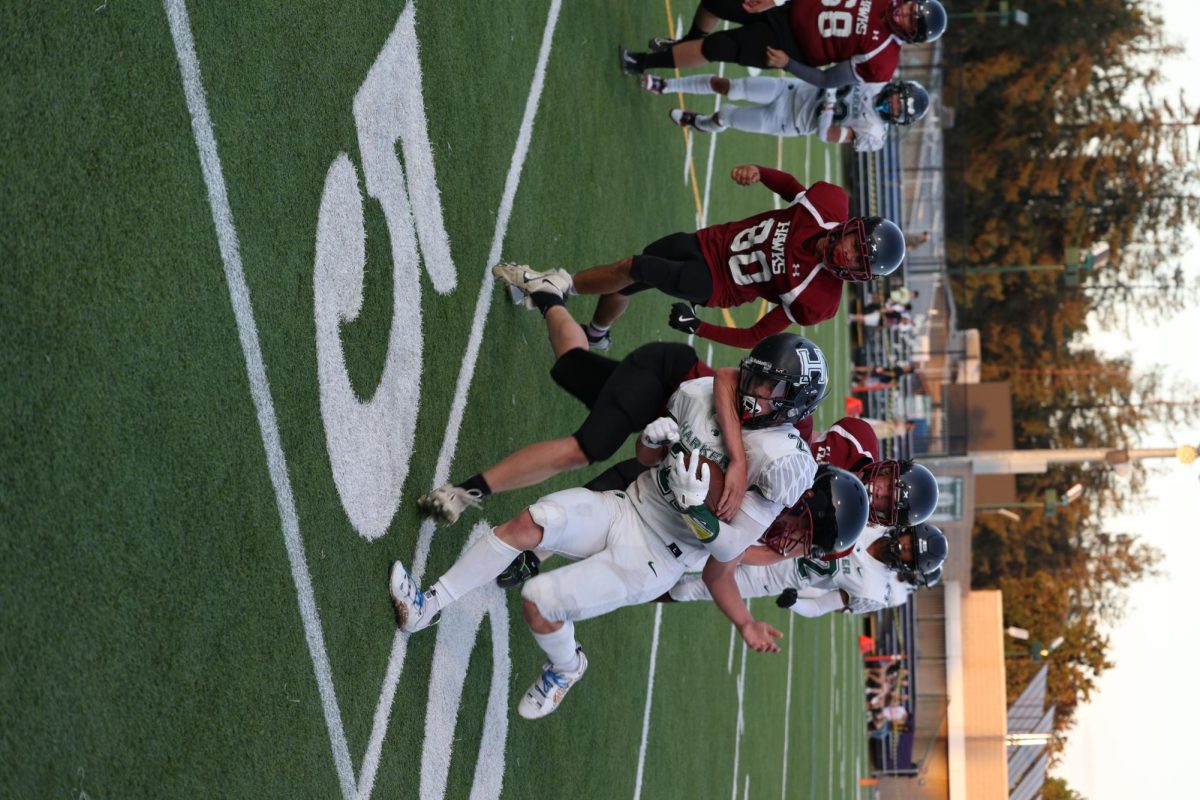 Hawks player tackles running back Jackson at the 50 yard line.