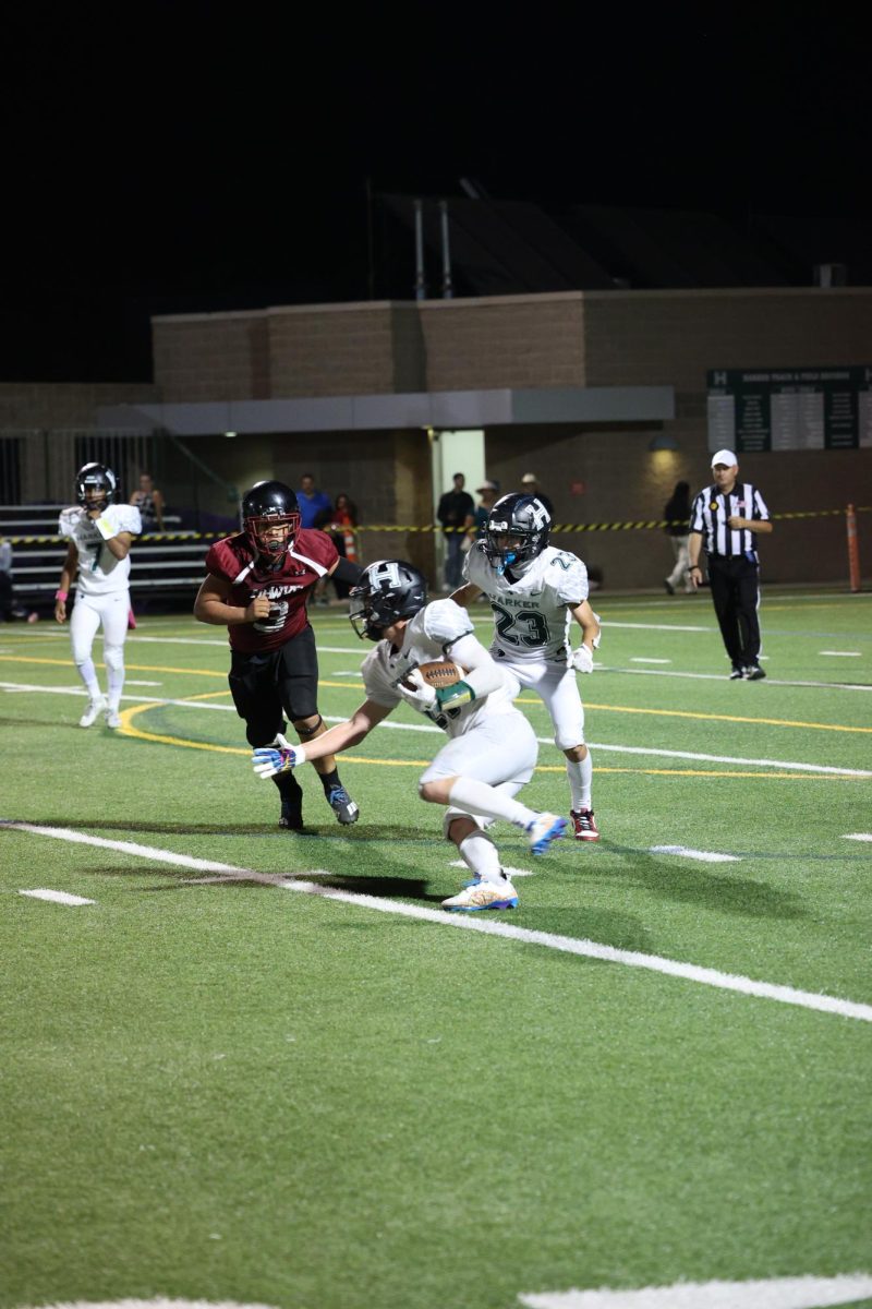 Running back Jackson darts past a Hawks defender as he drives the ball up the field. Jackson has scored two touchdowns for the Eagles so far.