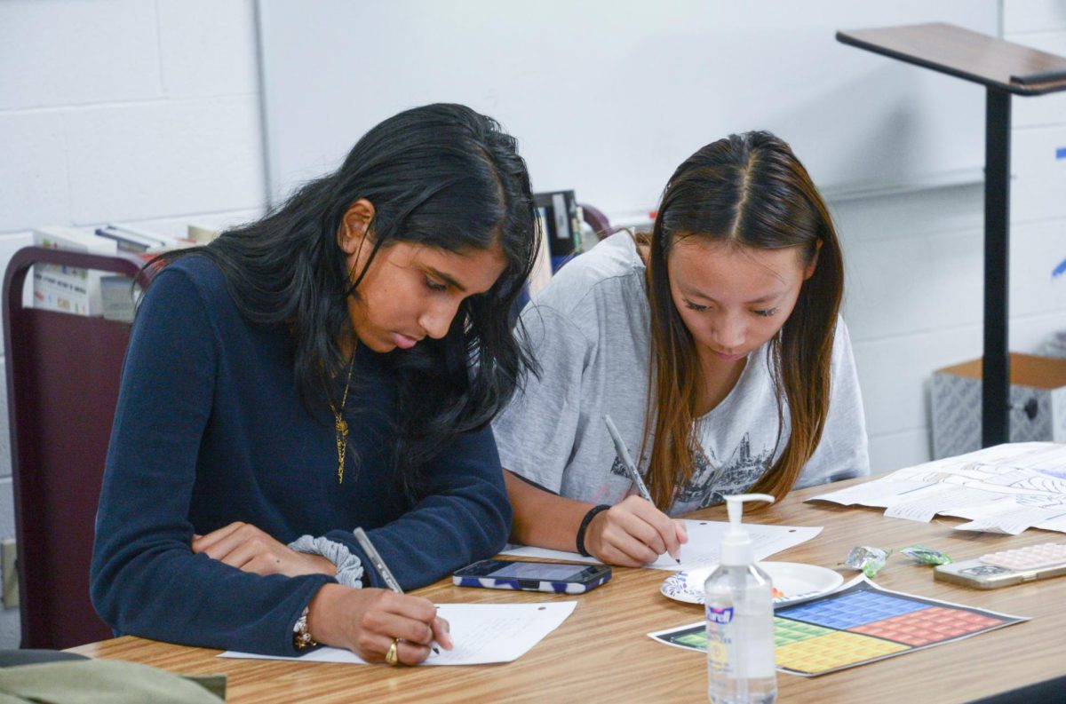 Sophomores Saahithi Koneru and Joyce He write letters to individuals currently in jail. Amnesty International planned to mail the letters to the victims as a sign of support and to advocate for their release.