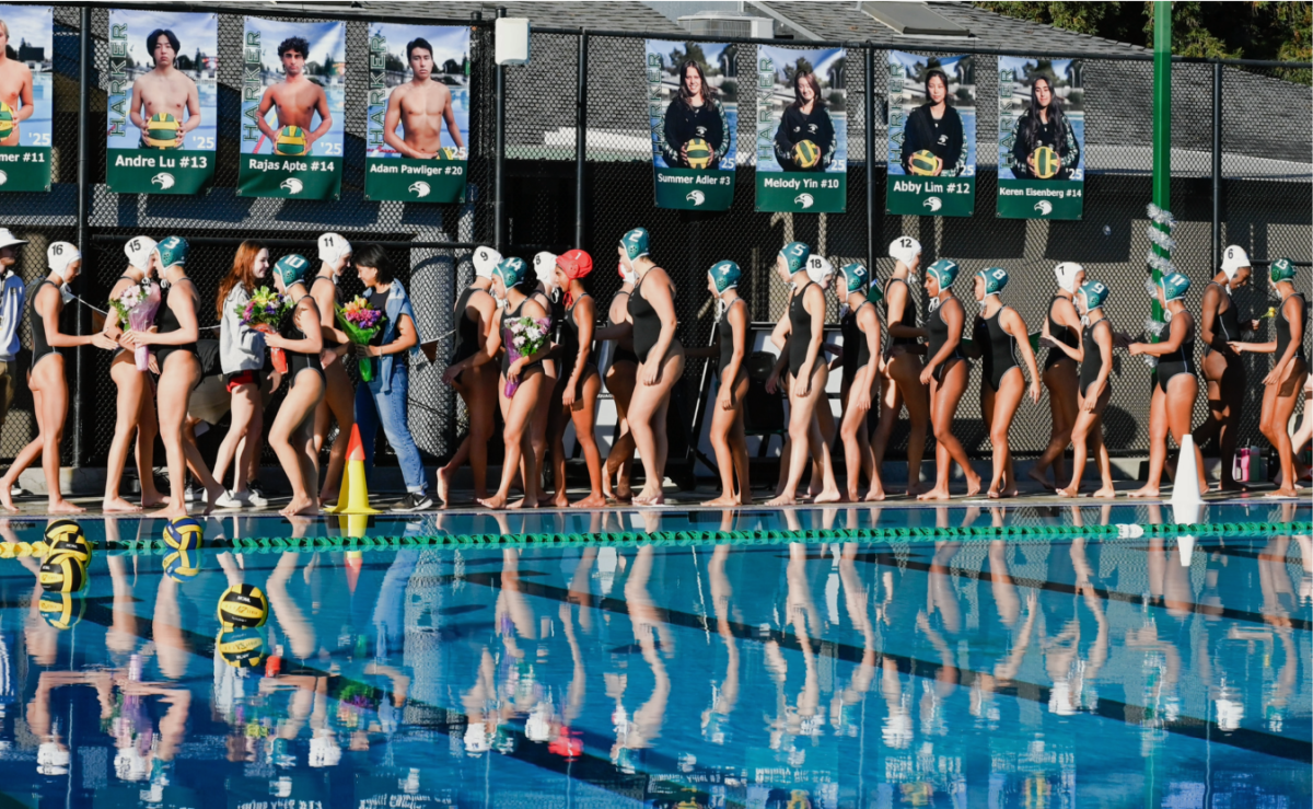 Varsity girls water polo team players high five members of the Mountain View team prior to their game. The Eagles beat their opponents 12-5 on senior night. 