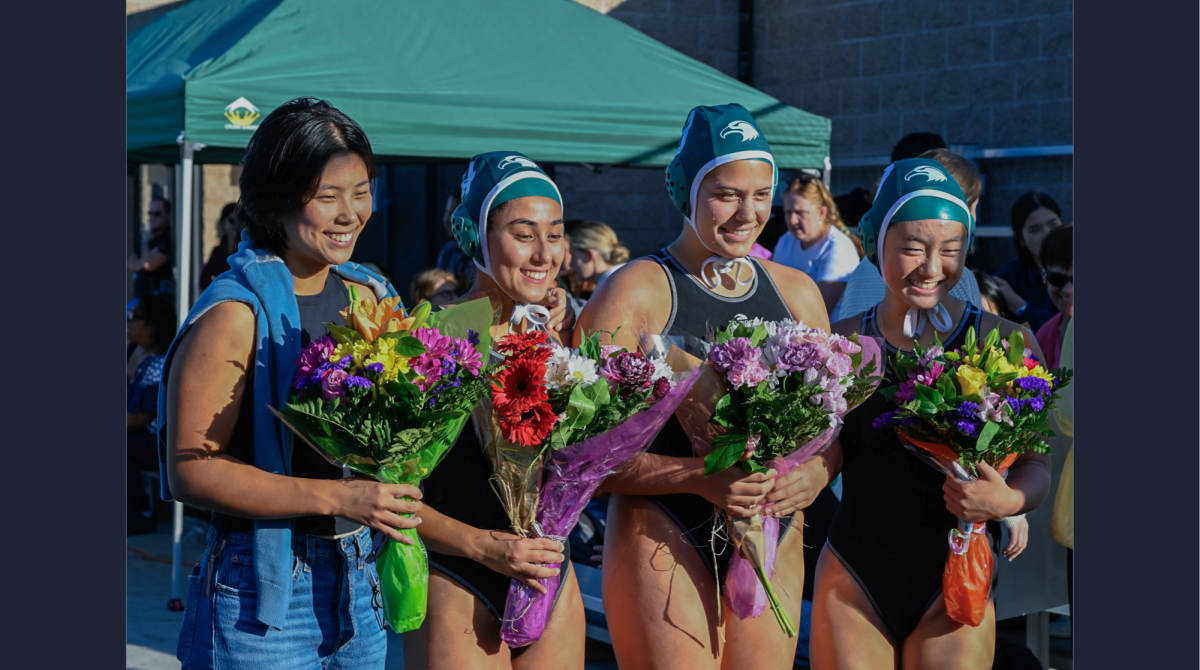 Seniors Abby Lim, Keren Eisenberg, Summer Adler and Melody Yin hold bouquets and pose for a photo during their senior night ceremony. Varsity girls water polo defeated Mountain View High School 12-5 on senior night. 