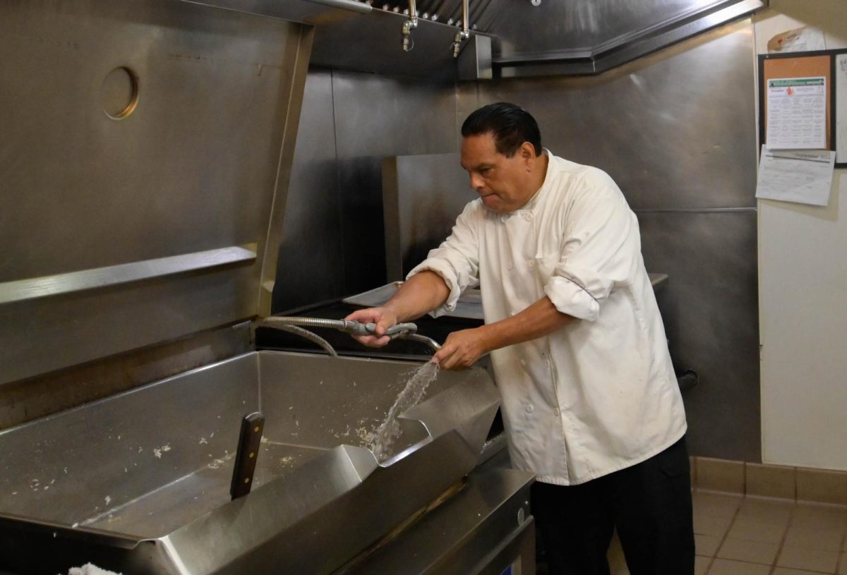 Mora hoses down the kitchen cooktop. Rice and large stir-frys are often prepared here. 