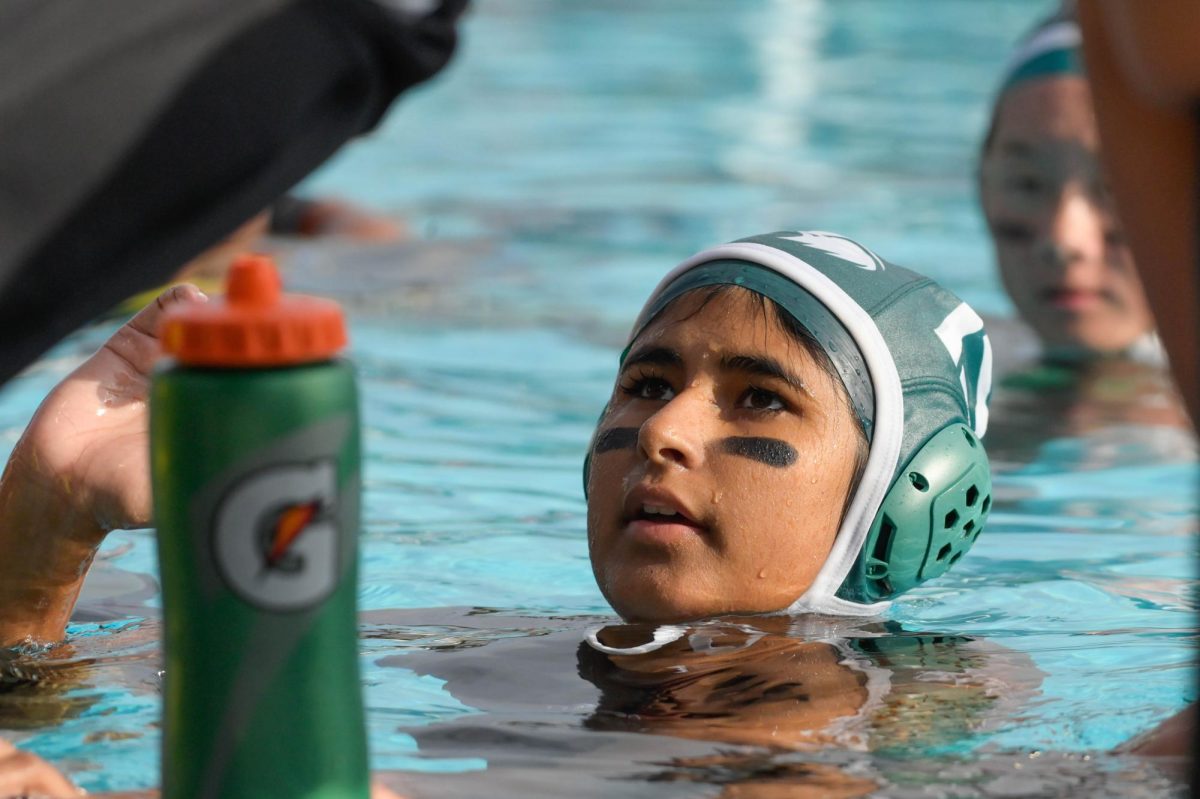 Varsity girls water polo player Anushka Madan (10) treads water as she listens to her coach during half time. Advancing to CCS playoffs, the team held a 20-9 overall league record.