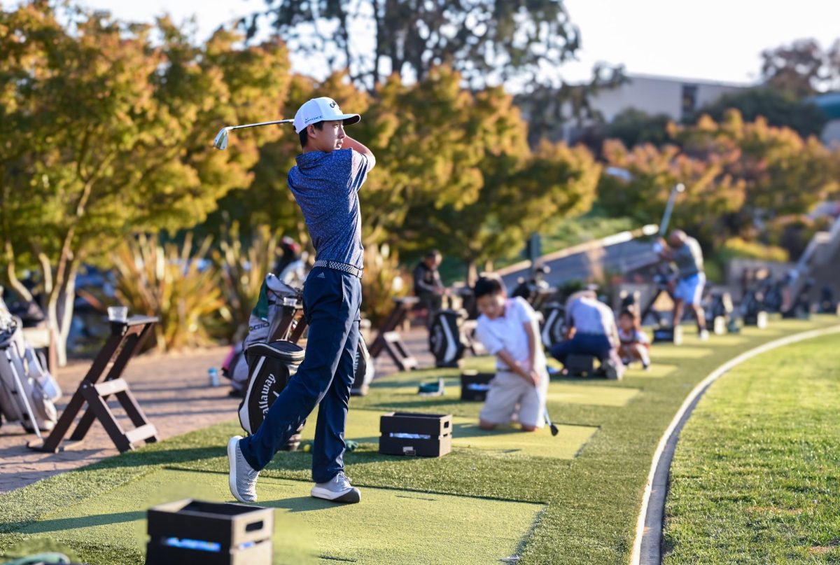 Justin swings his iron as he perfects his drive. Frequently leaving school early for golf practice, Justin spends over three hours each day training and traveling to matches.