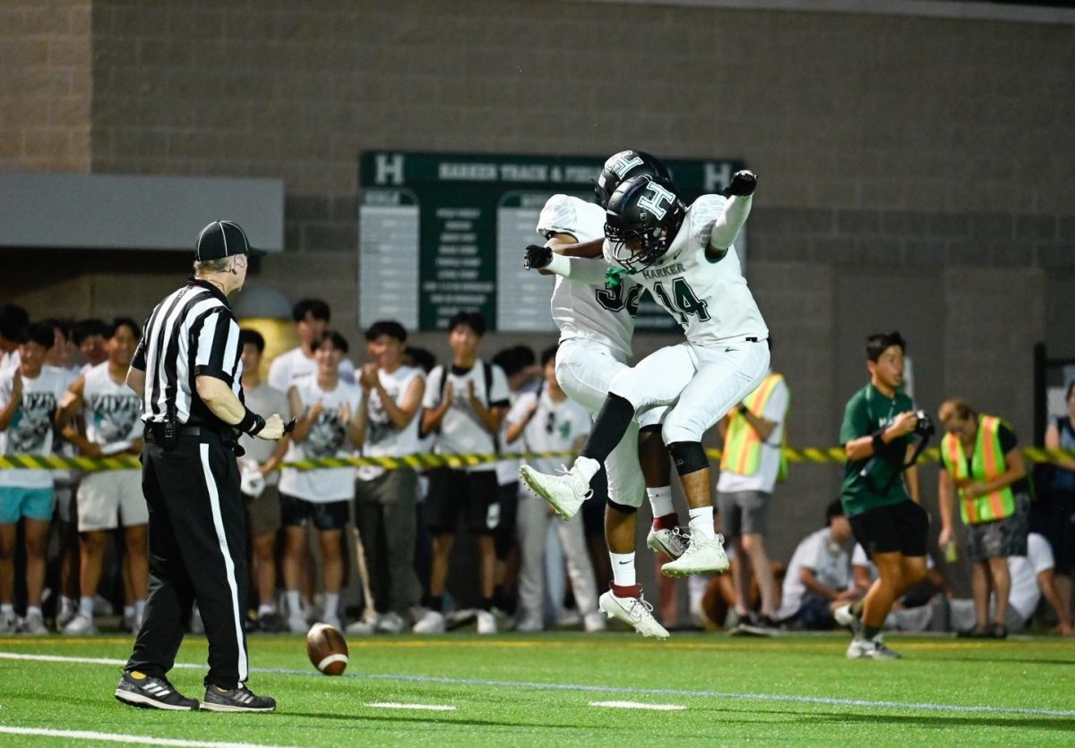 Wide receivers Arav Vuppula and Vedant Yadav leap into the air to celebrate an touchdown during the homecoming game. Harker dominated Anzar High School 35-0 during the match.