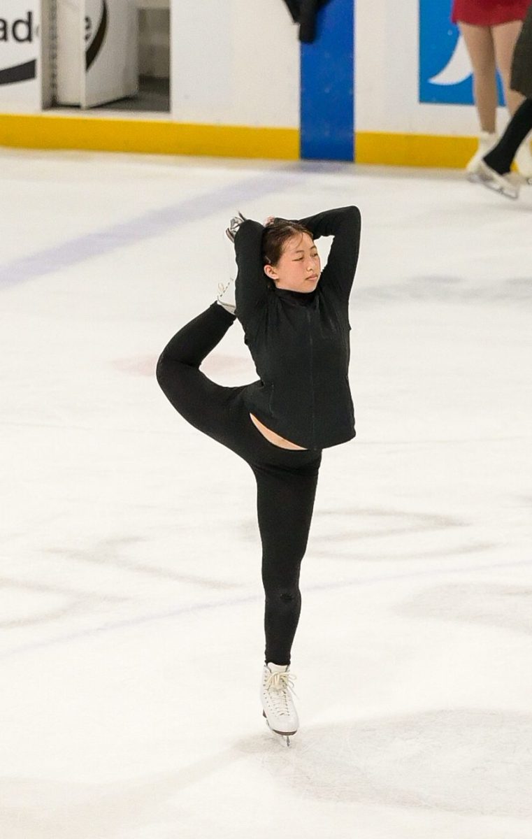 Christy holds her leg behind her head to execute a scorpion spin. Training for two hours each morning, Christy hones her skills for competitions.