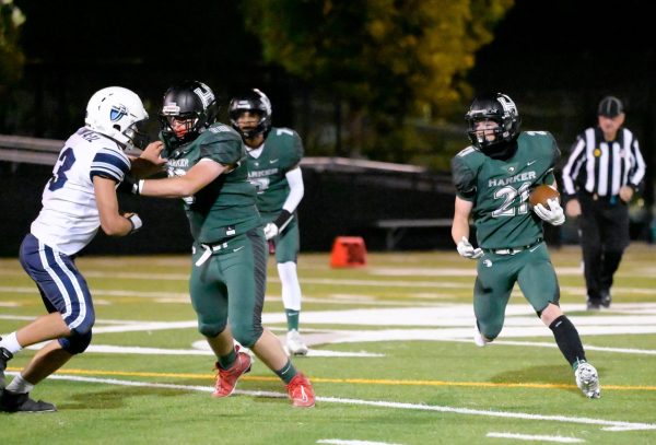 Running back Jackson Powell (11) sprints with the football as offensive lineman Henry Fradin (11) defends a Warriors player. The varsity football team demolished Trinity Christian 58-0 on senior night. 