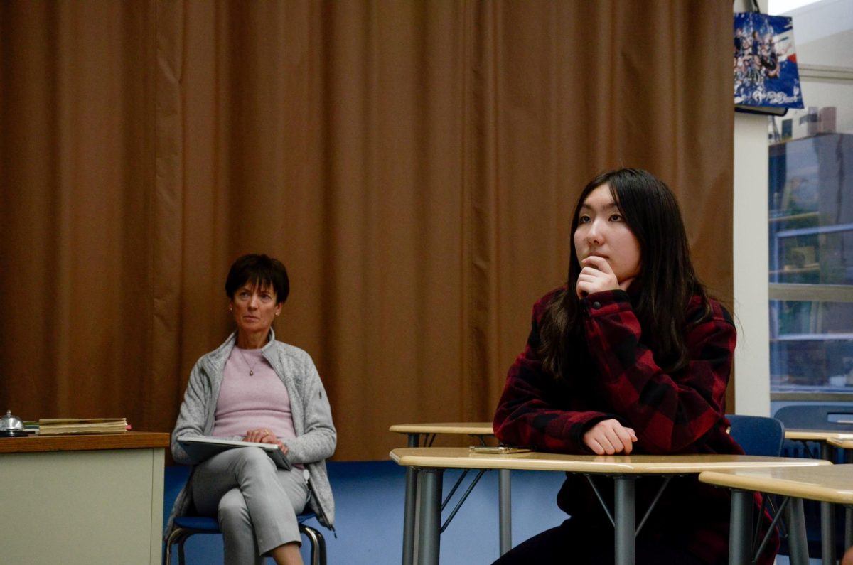 LALC officer Raeanne Li (10) listens to Dr. Allen Romano's talk about language models.  Raeanne organized the speaker event and moderated the audience questions and discussion.