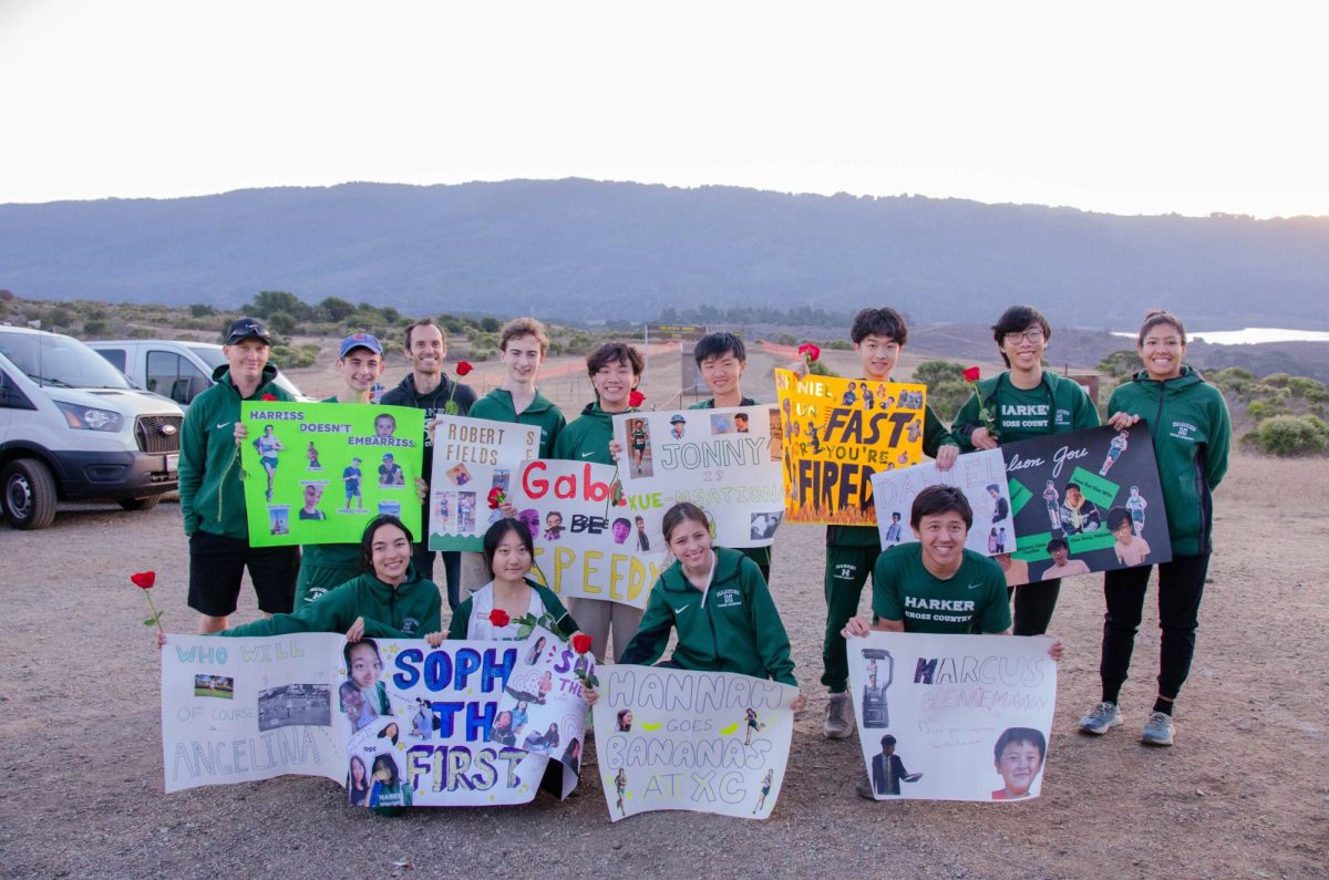 Senior cross country runners and their coaches pose with the posters their teammates made commemorating their time on the team. Every year, frosh, sophomore and junior athletes honor the graduating class by showering them with gifts and gratitude.