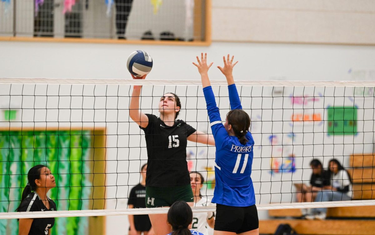 Senior middle hitter Emily Mitnick tips the ball over the net. The varsity girls volleyball team dominated Priory 25-16, 25-19, 25-10 during their senior night game. 