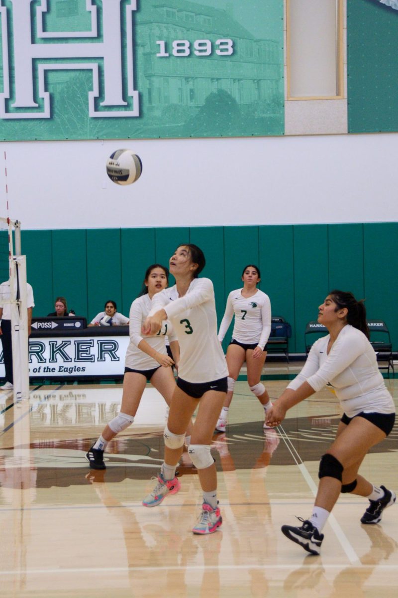 Junior varsity girls volleyball outside hitter Ashley Zhou (9) bumps the ball over the net. During their match against Eastside College Prep, the Eagles prevented their opponents from scoring a single point, shaving their coach's head in a previously agreed upon pact.