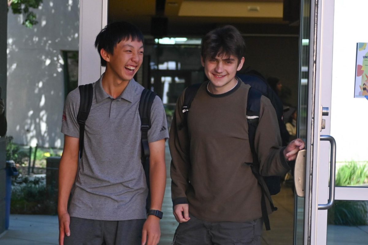 Justin laughs with frosh Micheal Chinkov as they walk to class after lunch. To stay on top of his academic assignments, Justin takes advantage of long lunches to finish his homework.