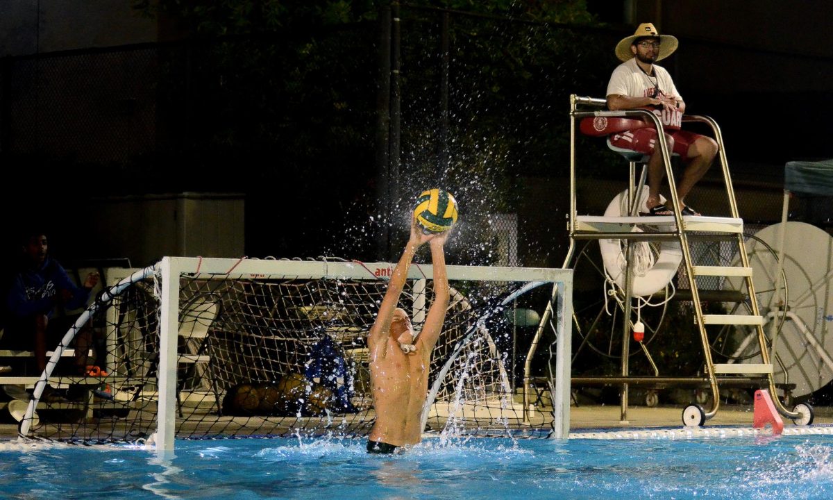 Junior varsity boys water polo goalie Luka Degoricija (10) leaps out of the water to make a save. The team finished their season with an overall record of 6-6.