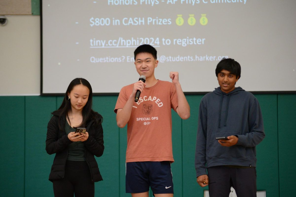 Kallie Wang (11), Neel Kumar (10) and Pascal Qin (10) announce the upcoming Harker Physics Invitational. Winners can receive up to $1000 in cash.