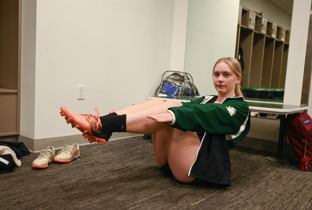 Junior Natalie Barth holds a boat pose, a position in Pilates that requires core stability. Natalie practices Pilates frequently at home by following YouTube videos.