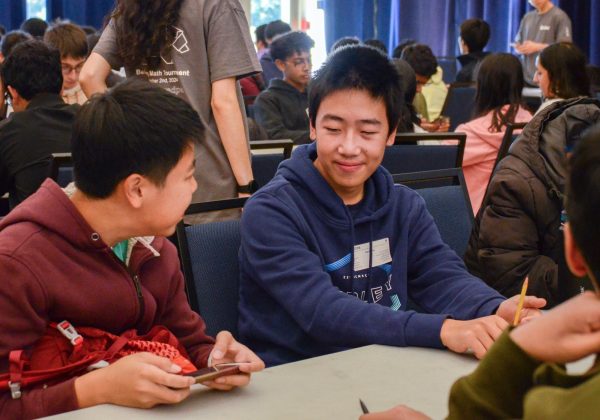 Sophomore Kevin He smiles as he chats with fellow competitors at the Berkeley Math Tournament. A record high of 45 students attended this year, competing against 1,000 students from across the nation.