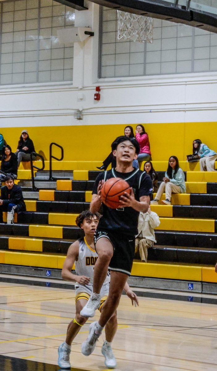 Shooting guard Bowen Xia (12) blows by his defender to score a fast-break layup. The Eagles used full-court press defense to disrupt the Del Mar passing game and generate fast-break scoring opportunities.