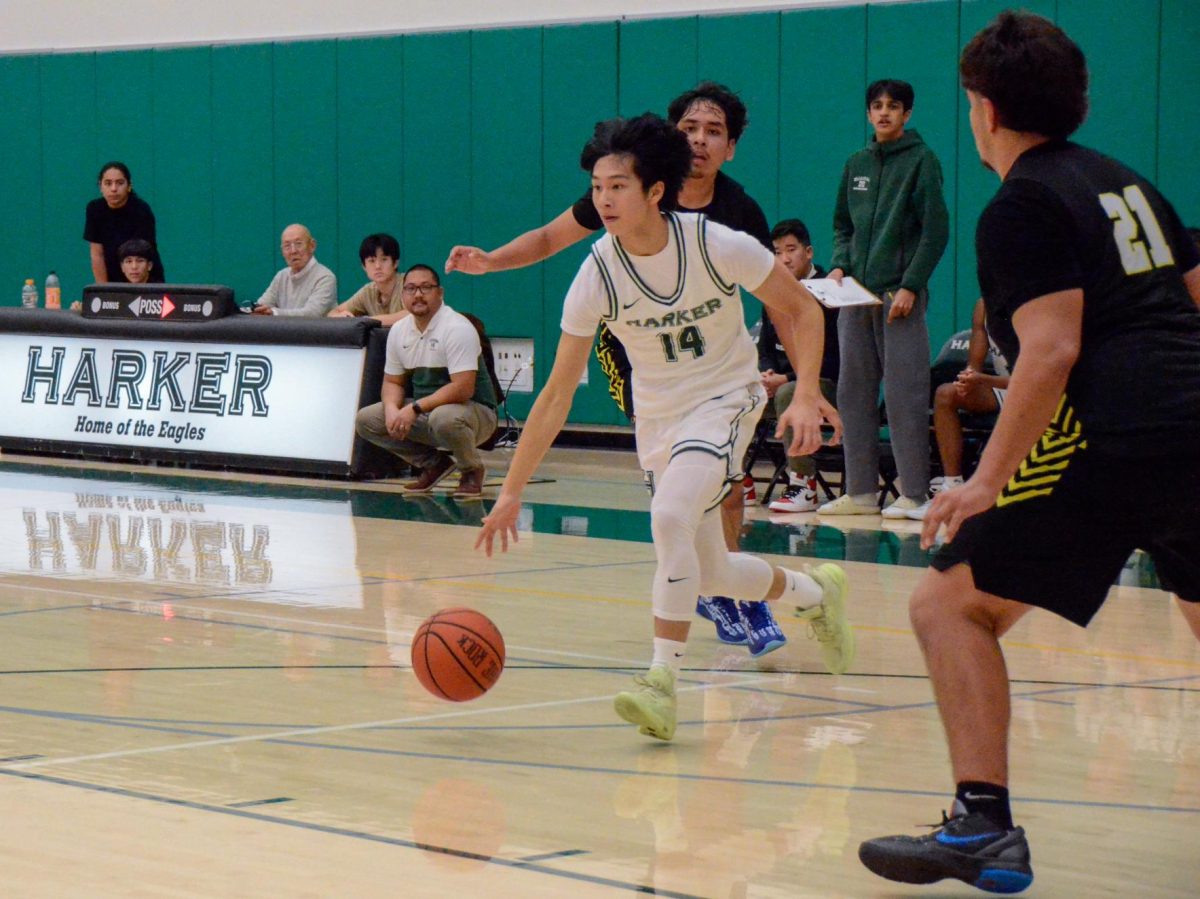 Shooting guard Lucas Huang (9) dribbles the ball against Andrew Hill defenders. The varsity boys basketball team defeated their opponents 68-56. 