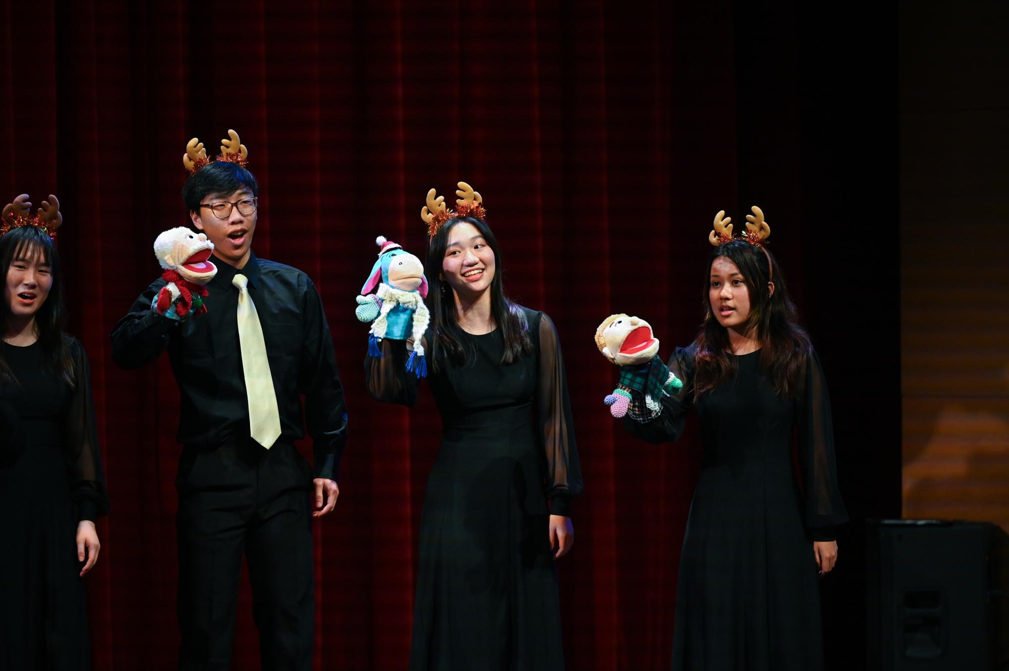 Junior Carissa Wu sings while holding an animal puppet during Capriccio's acappella rendition of "Animal Greetings." The performance weaved together each member's animal sound to create a harmony.