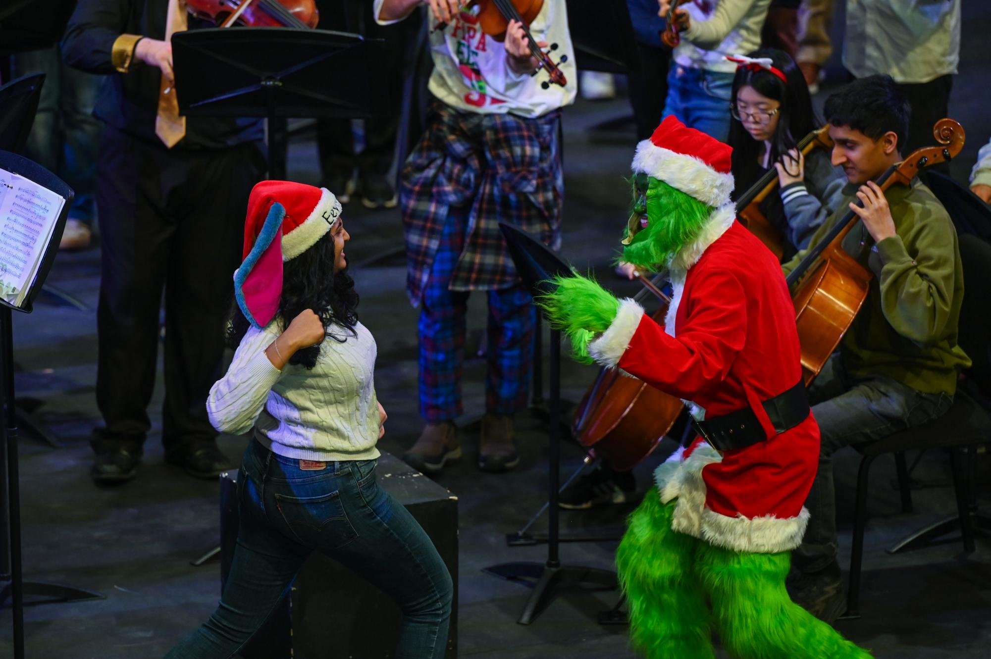 Orchestra member Savitha Satish (11) prepares to throw a playful jab at Orchestra director Jaco Wong. Savitha took over Wong's position as conductor.