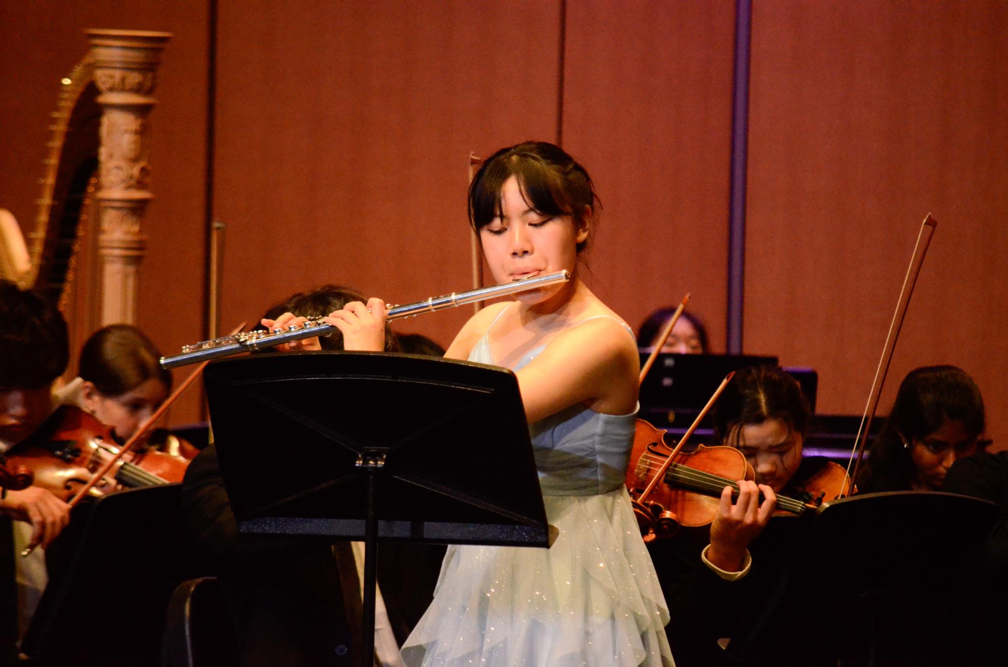 Senior Jessica Wang performs her solo on the flute. She was chosen to perform at the Winter Instrumental Concert after Orchestra’s annual concerto competition.