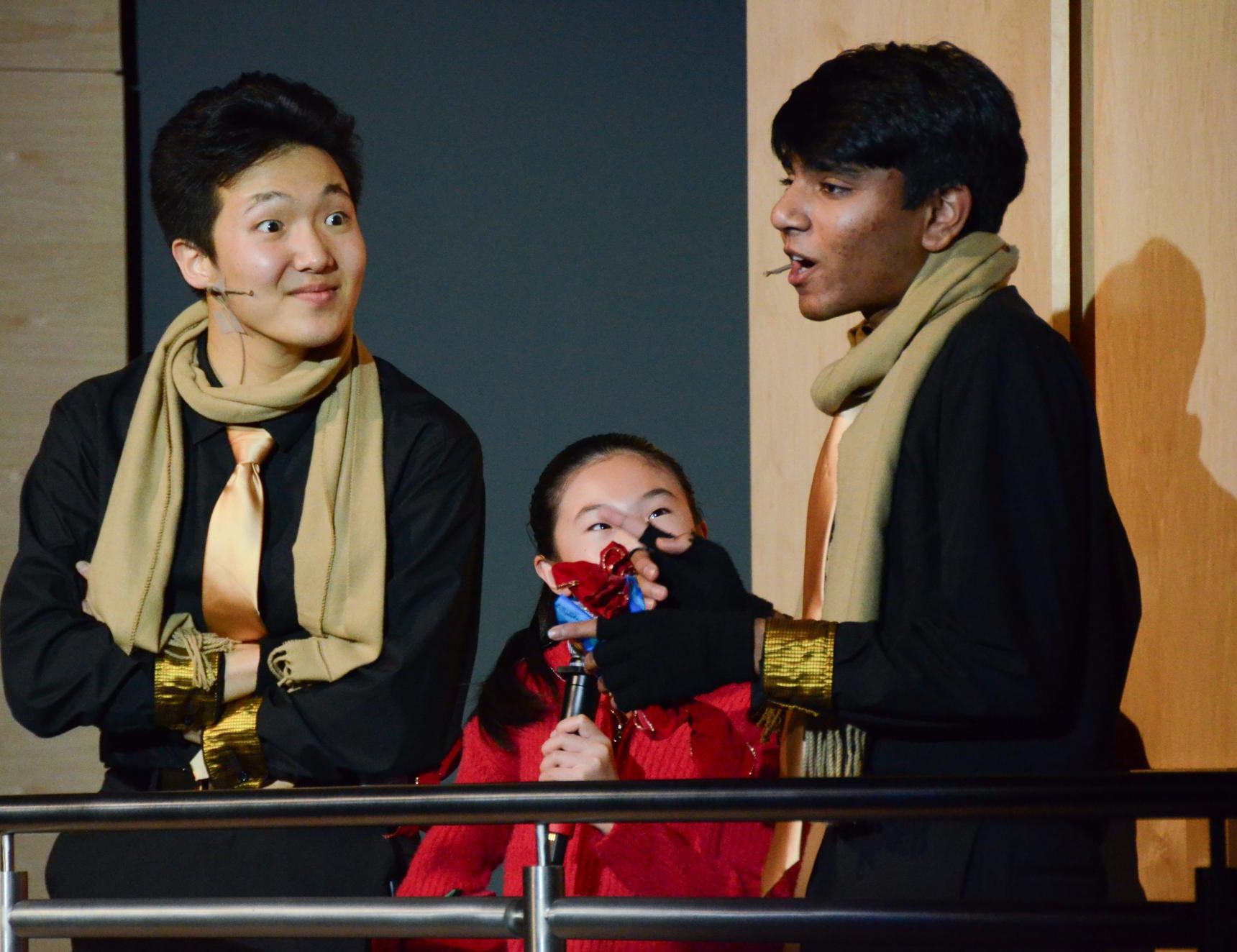 Seniors Jason Shim and Varun Bhupathi and a lower school Dance Fusion member introduce the next acts. Jason and Varun also performed in Downbeat's performance of “Twelve Days of Christmas Confusion.”