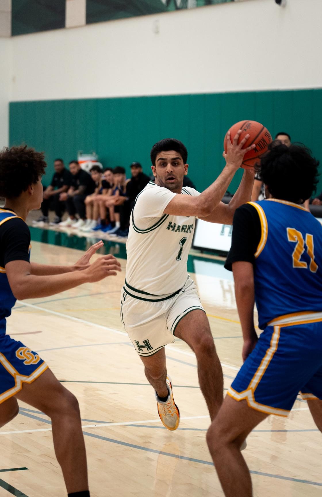 Center Vyom Vidyarthi (12) eurosteps to the basket through traffic. Also the captain of the boys varsity water polo team, Vyom leveraged his physicality on both ends of the floor, scoring 4 points and grabbing 10 rebounds.