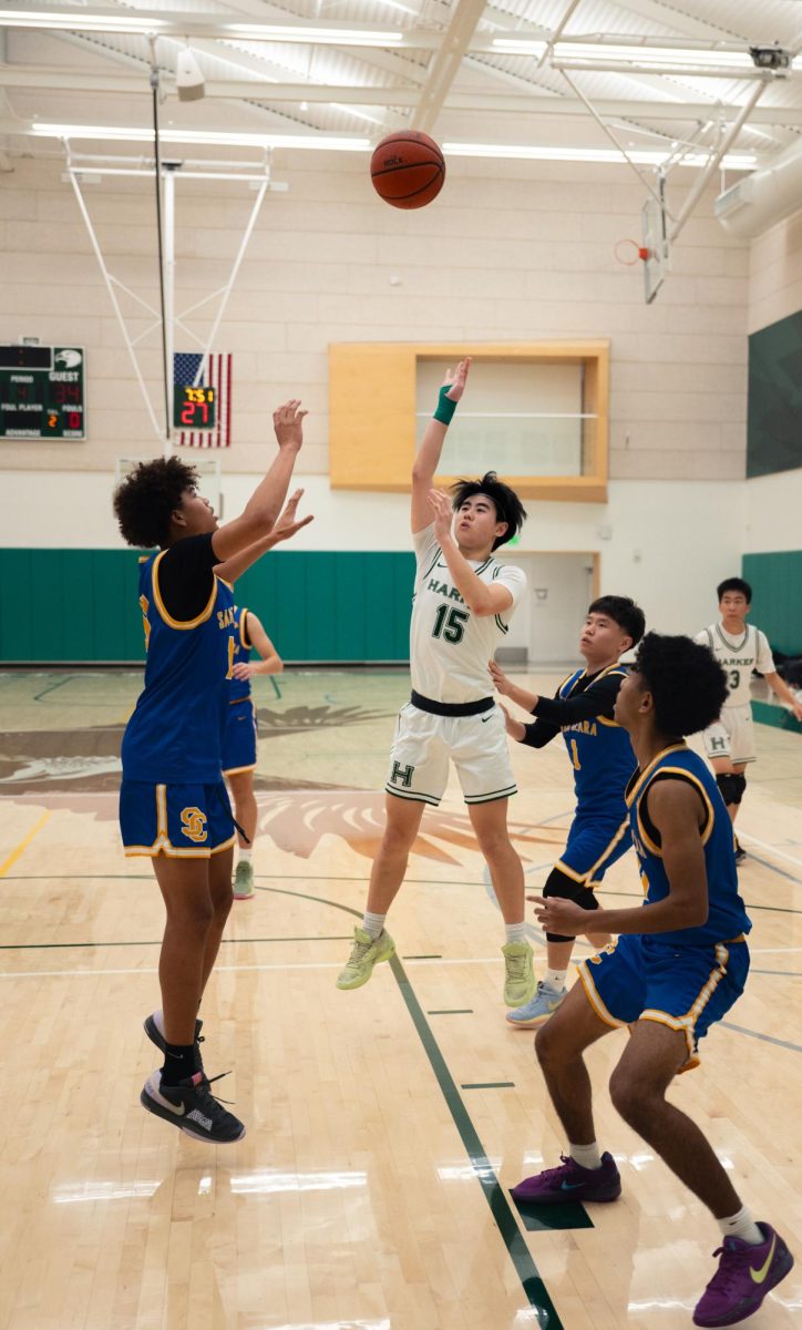 Shooting guard Alan Gao (11) stops his drive short and puts up a floater. Alan contributed 8 points to the Eagles despite returning to the court from a sprained wrist.