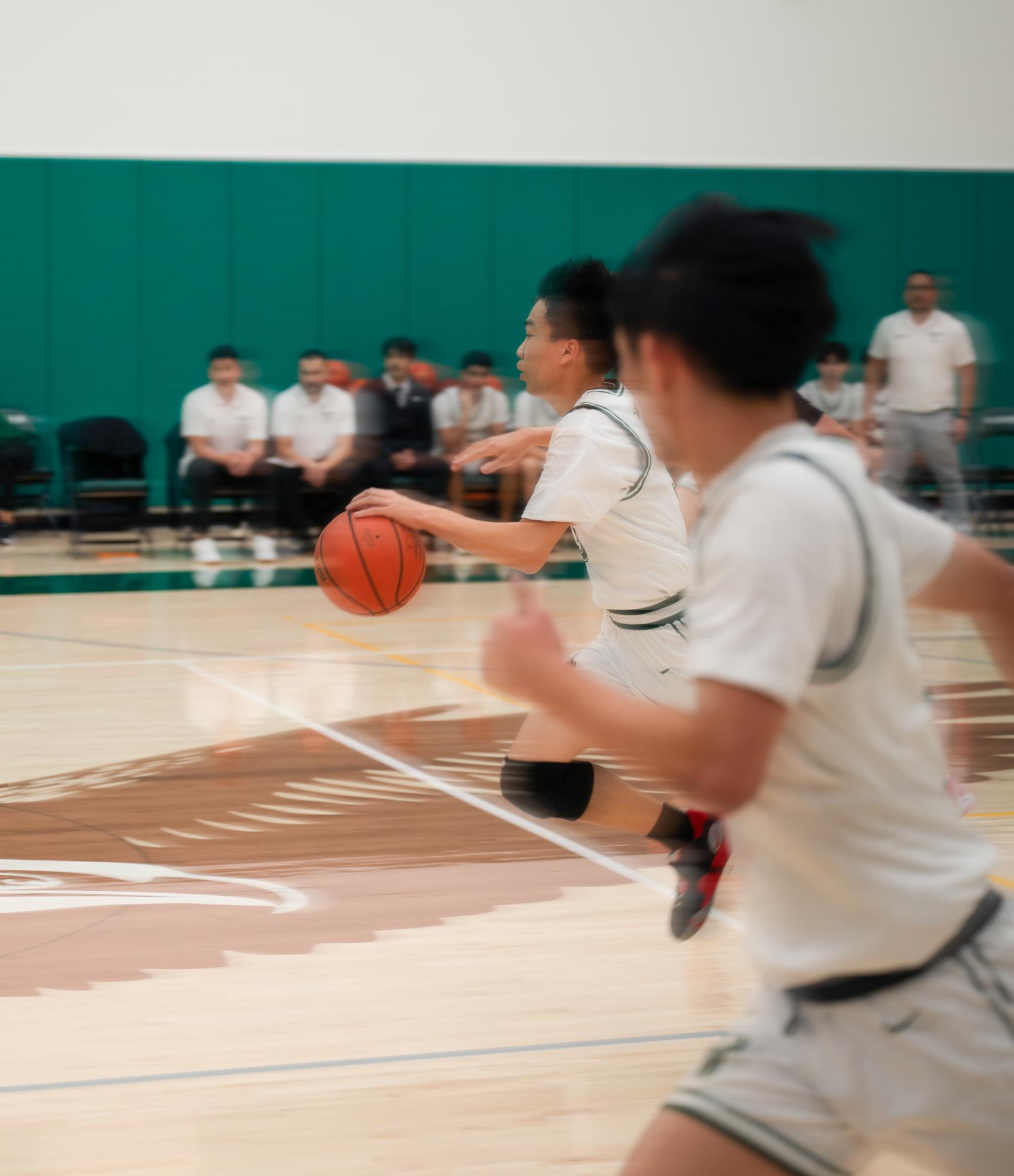 Junior guard Caden Ruan (11) sprints up the court for a fast break layup. Caden led the team in steals with six, which allowed the Eagles to turn the Bruins’ offense in their favor.