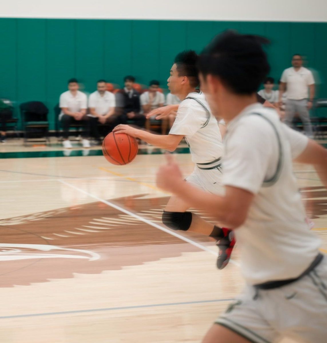 Junior guard Caden Ruan (11) sprints up the court for a fast break layup. Caden led the team in steals with six, which allowed the Eagles to turn the Bruins’ offense in their favor.