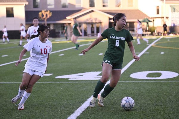 Midfielder Eva Cheng (11) keeps the ball away from defenders. The girls won the game and brought their league record up to 5-2 overall.