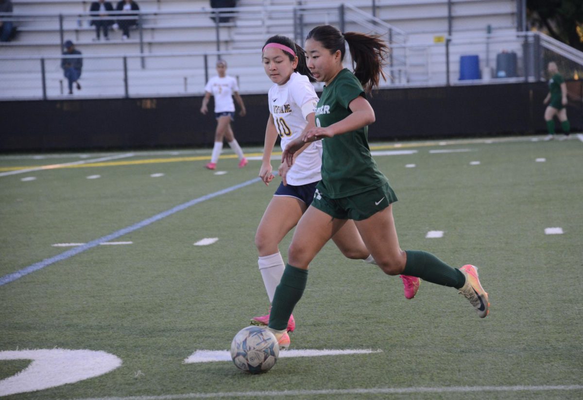 Left midfielder Eva Cheng (11) steals the ball from the other team. She sustained a kick to the leg in the second half but continued to control the midfield after as well.