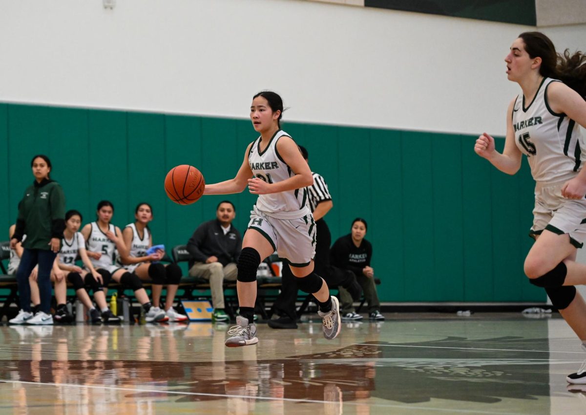 Guard Isabella Lo (12) drives the ball. The varsity girls basketball team currently holds an overall 10-1 record.