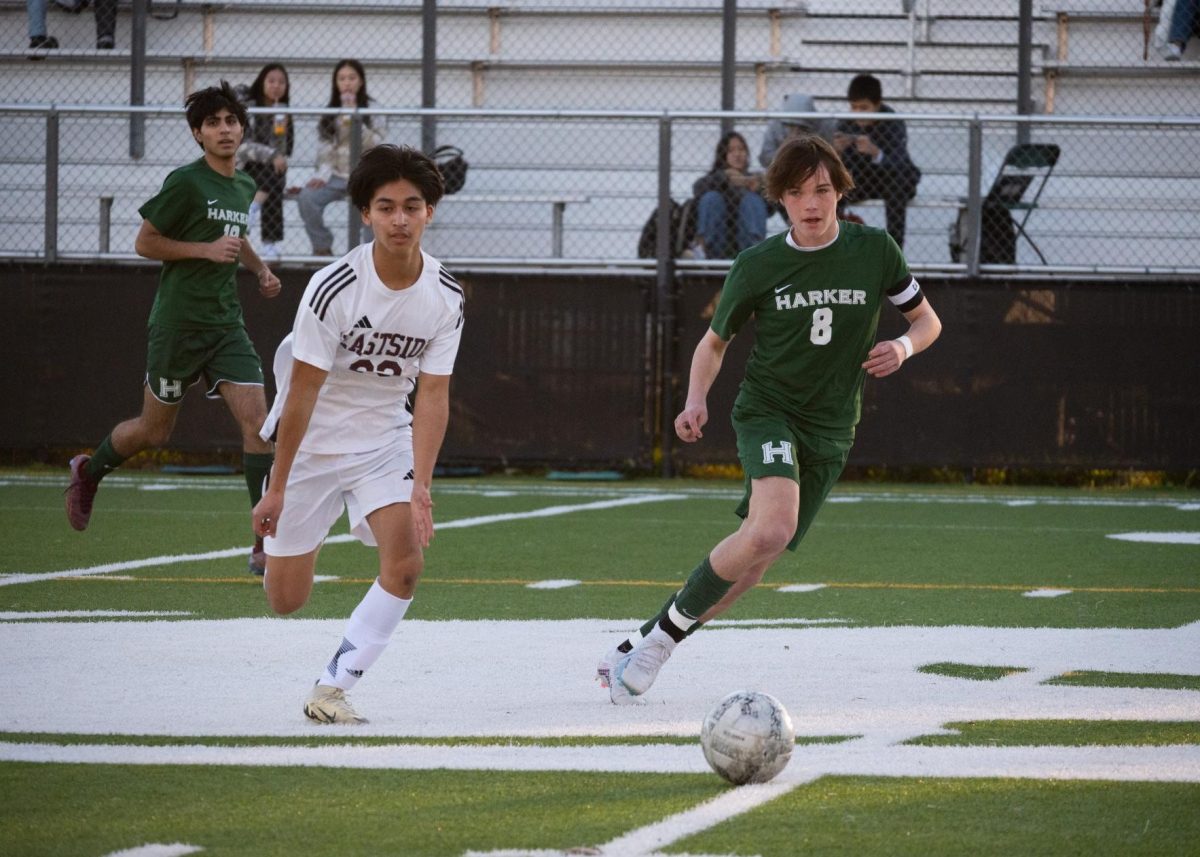 Forward Ryder Hewitt (11) dribbles the ball away from an Eastside defender in the middle of the field. The Eagles dominated offensively, scoring a goal within the first ten minutes of the match.