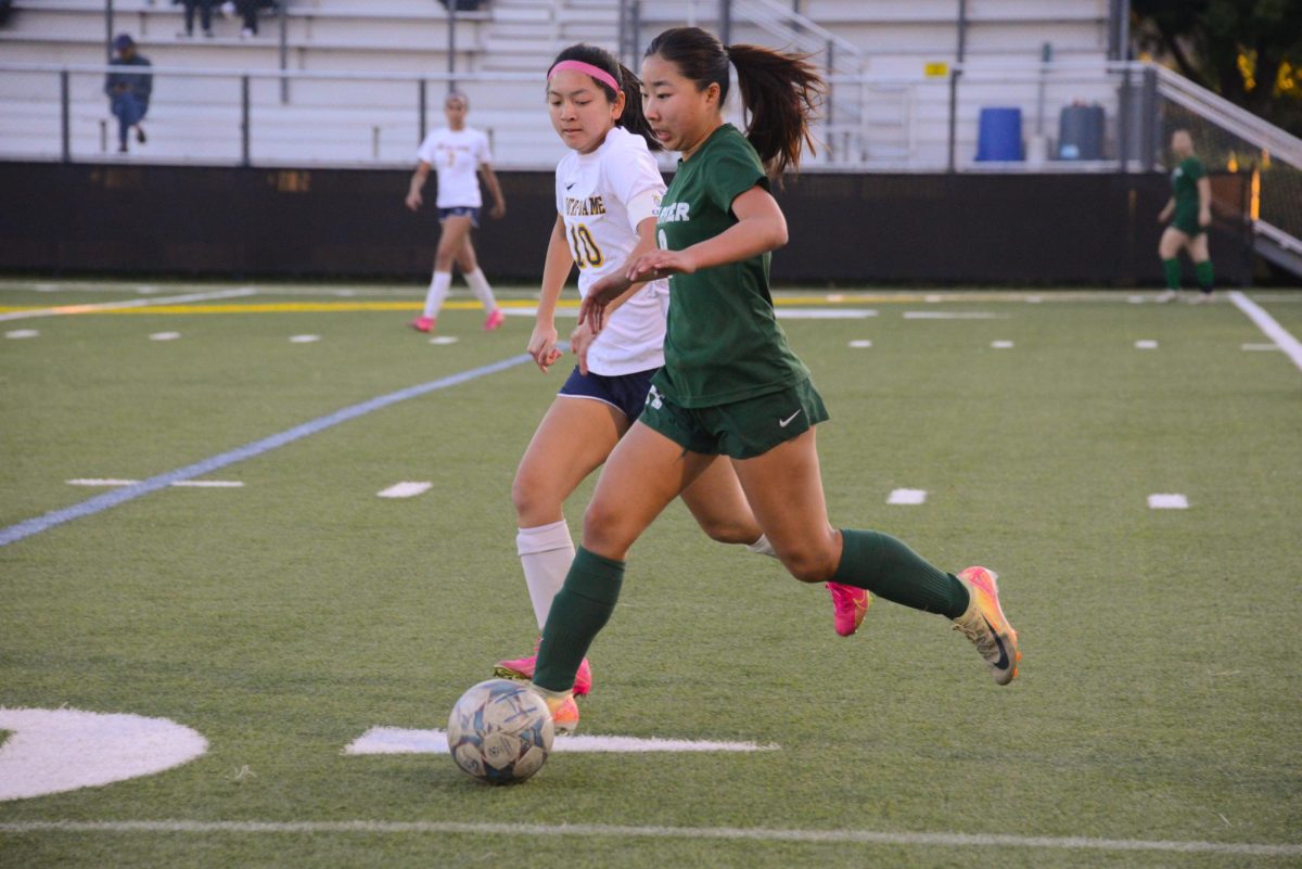 Left midfielder Eva Cheng (11) steals the ball from the other team. She sustained a kick to the leg in the second half but continued to control the midfield after as well.