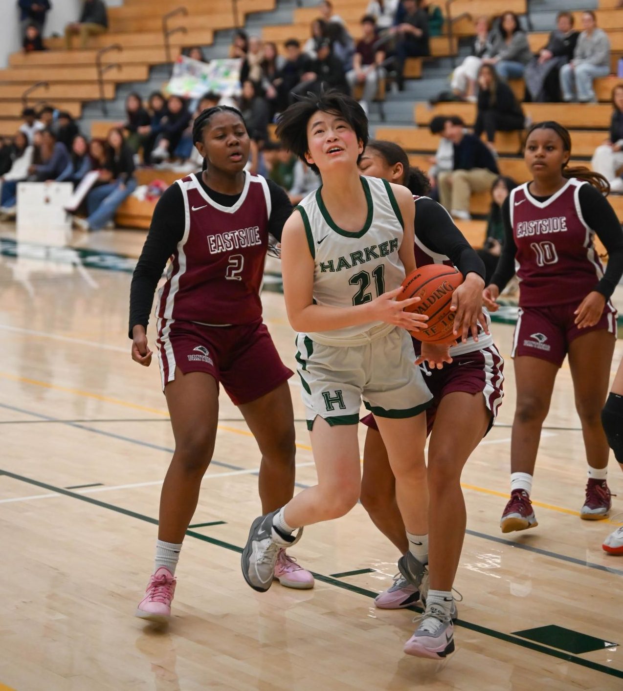 Guard Finley Ho (10) wrestles with an Eastside defender as she eyes the basket. Finley contributed 7 points, 4 rebounds, and 4 steals to the Eagles' 57-15 victory.