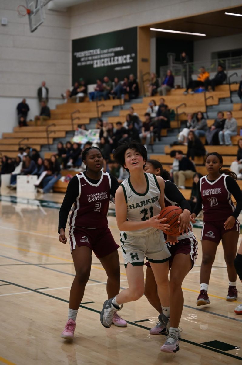 Guard Finley Ho (10) wrestles with an Eastside defender as she eyes the basket. Finley contributed 7 points, 4 rebounds, and 4 steals to the Eagles' 57-15 victory.