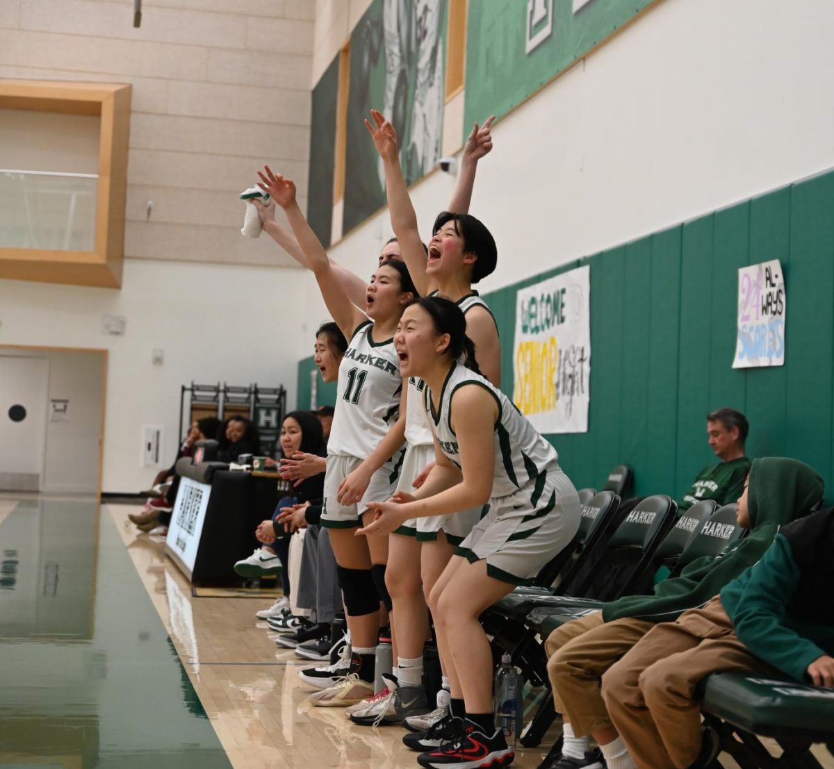 Jillian Chen (9), Finley Ho (10), and Sophia Wu (9) celebrate a three-pointer from guard Gemma Chan in the third quarter. She scored another three-pointer in the first half for a total of six points.