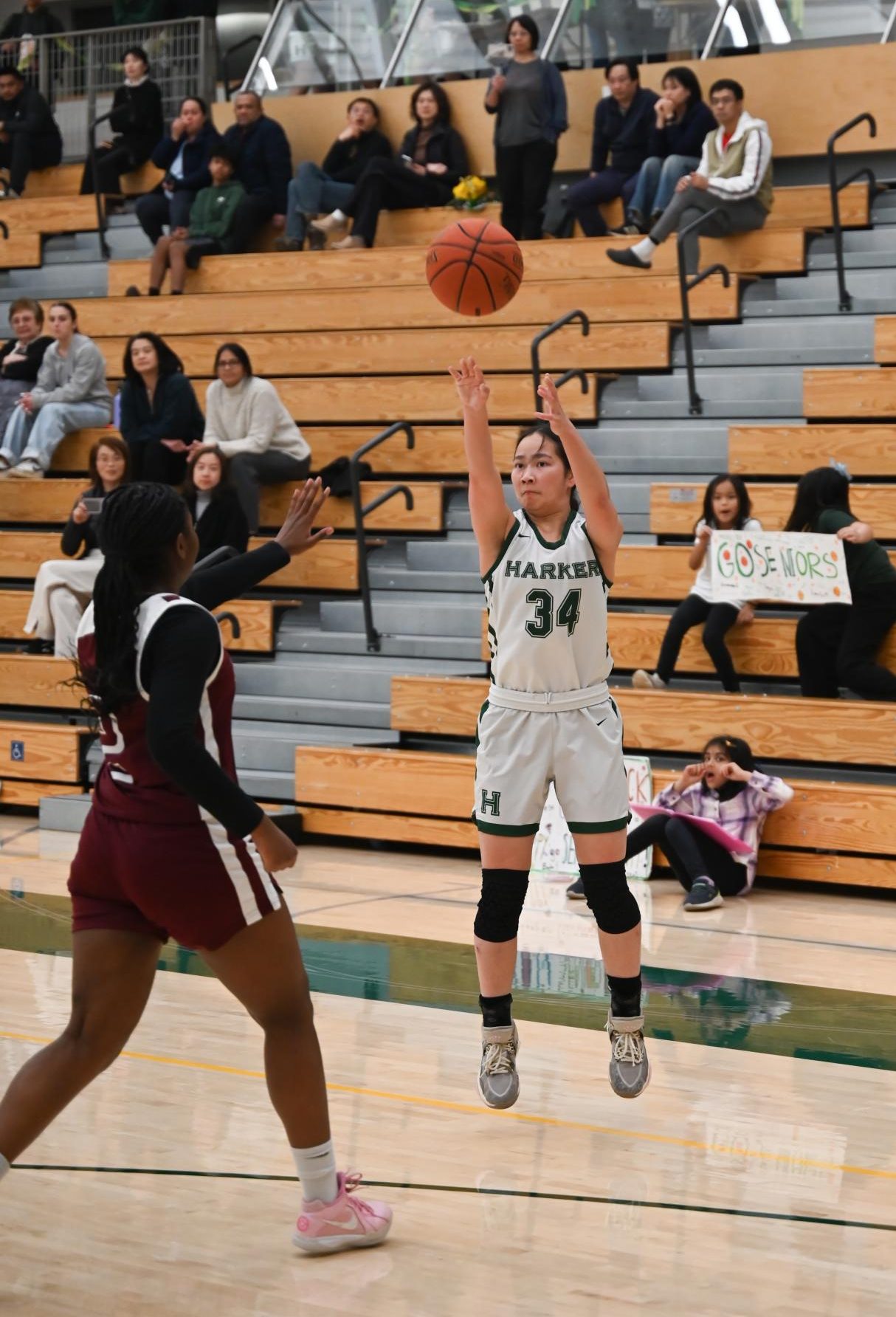 Guard Isabella Lo sinks a three pointer as fans look on from behind. Isabella spaced out the Eastside defense by shooting 60% from three, opening up the paint for passes to fellow senior Emily Mitnick.