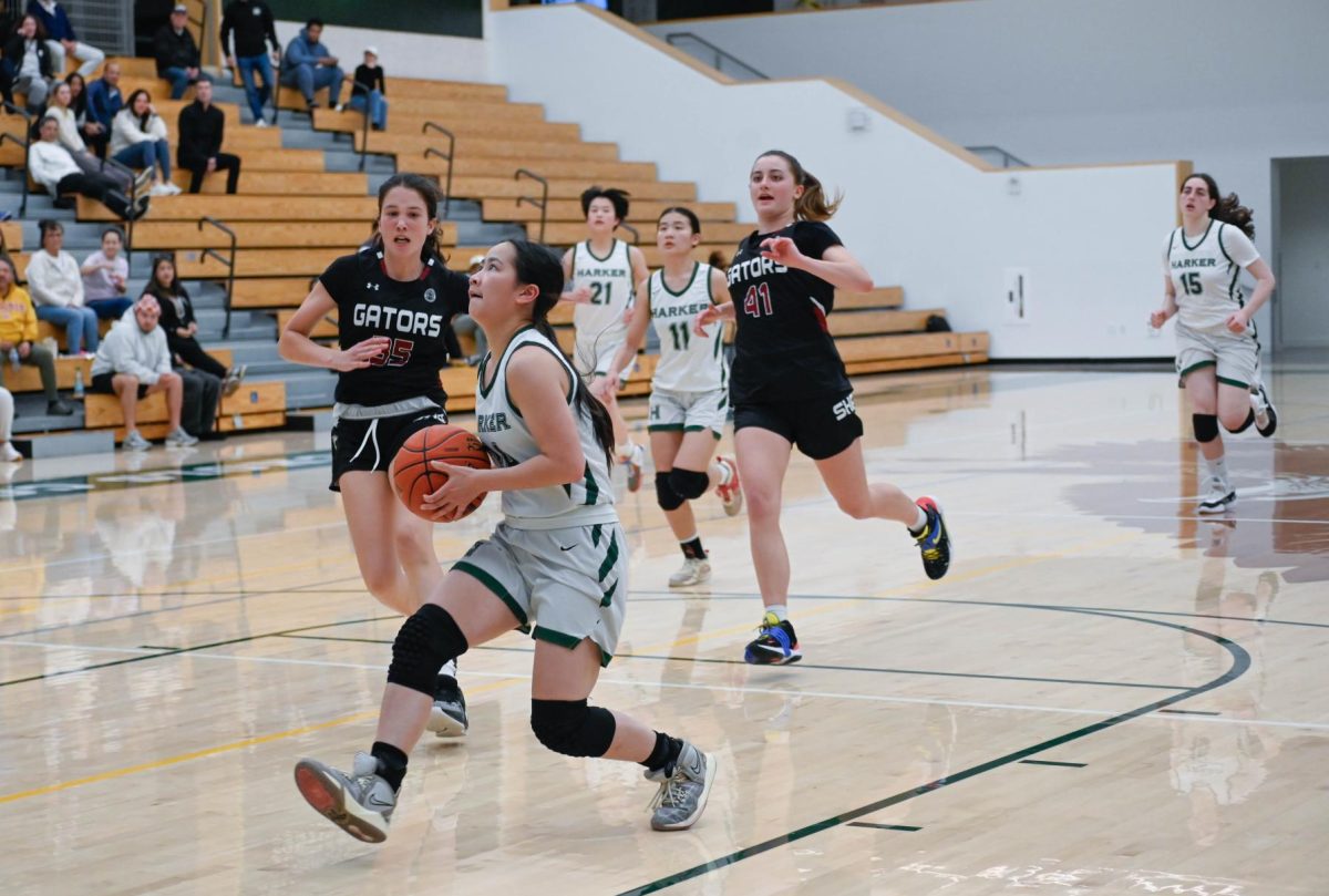 Point guard Isabella Lo (12) prepares for a layup during the third quarter. Isabella went on a seven point streak to extend the Eagles' lead to 56-18 by the end of the period.