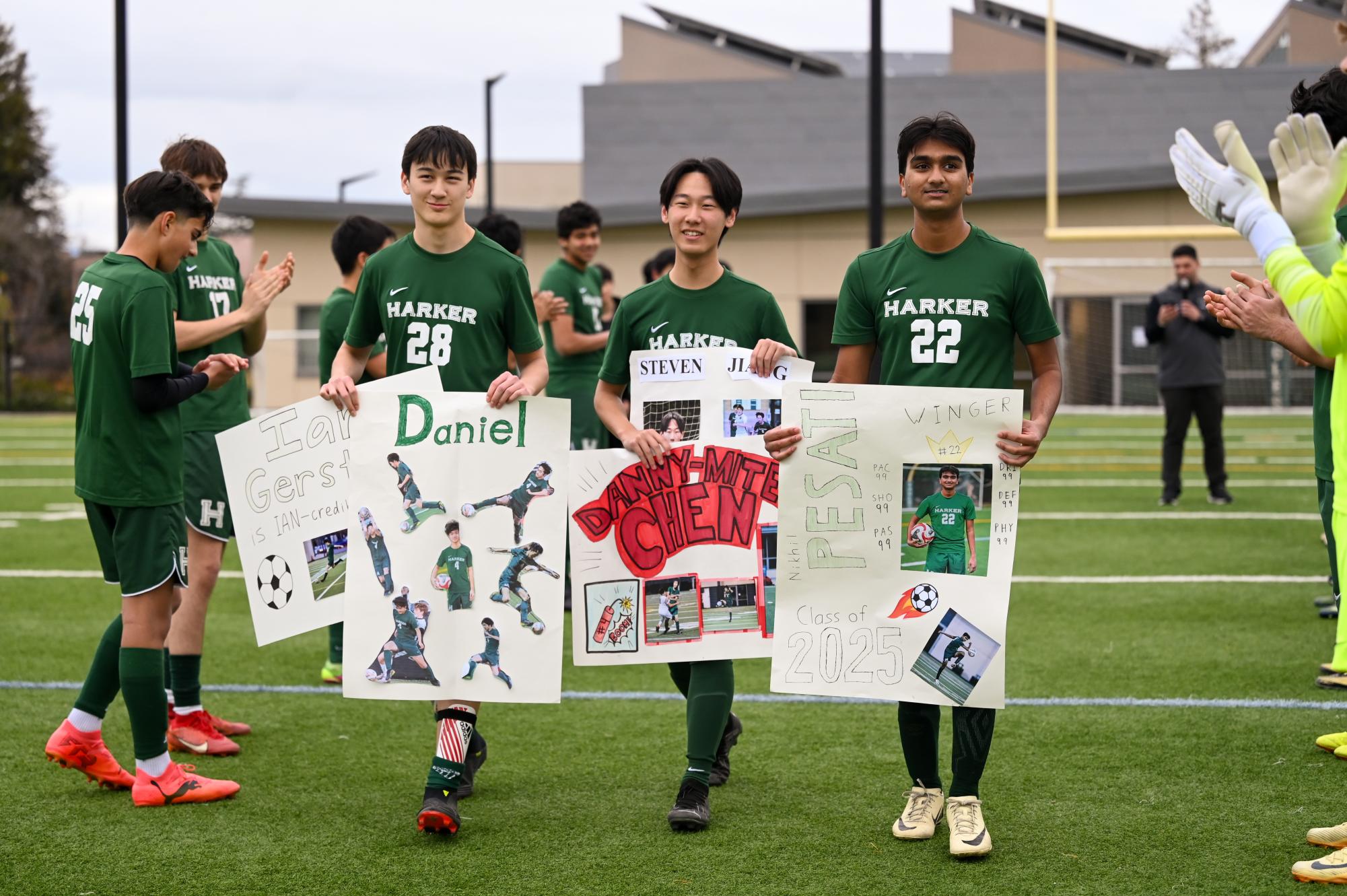 Seniors Ian Gerstner, Steven Jiang and Nikhil Pesati boast posters during the ceremony. Although Senior Daniel Chen was unable to attend, Ian and Steven carried his posters for him. 